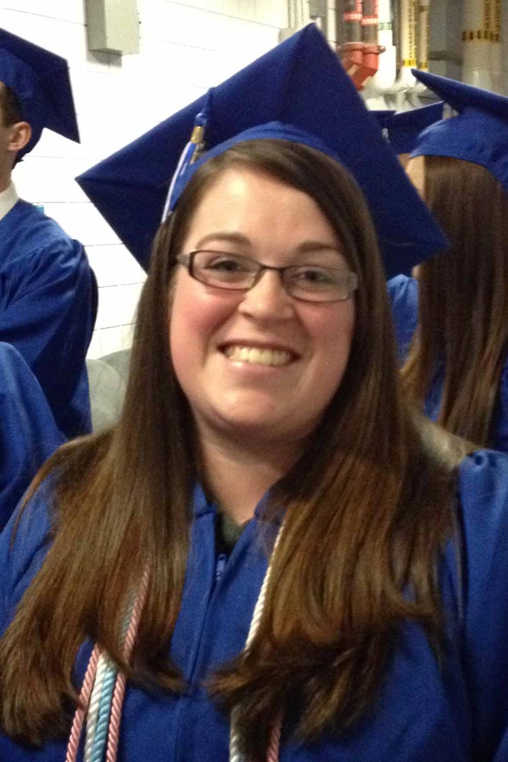 Photo of Ashley in cap and gown before Fall 2016 Commencement Ceremony.